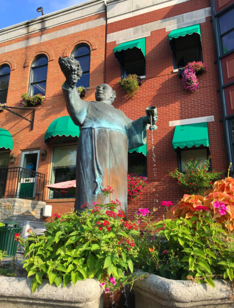 Father Quinn Statue with Flowers